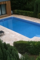 Swimming pool surrounded by paved area.