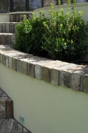 Brick steps and a wall with planters